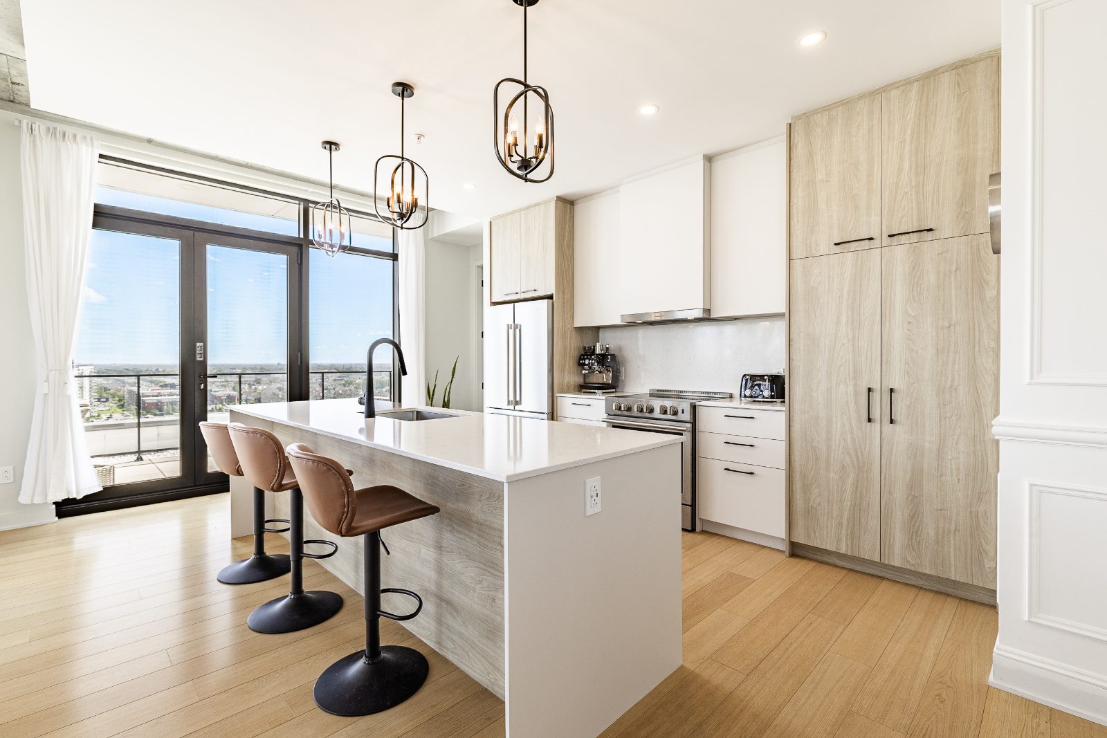 Bright kitchen with central island and quartz countertops