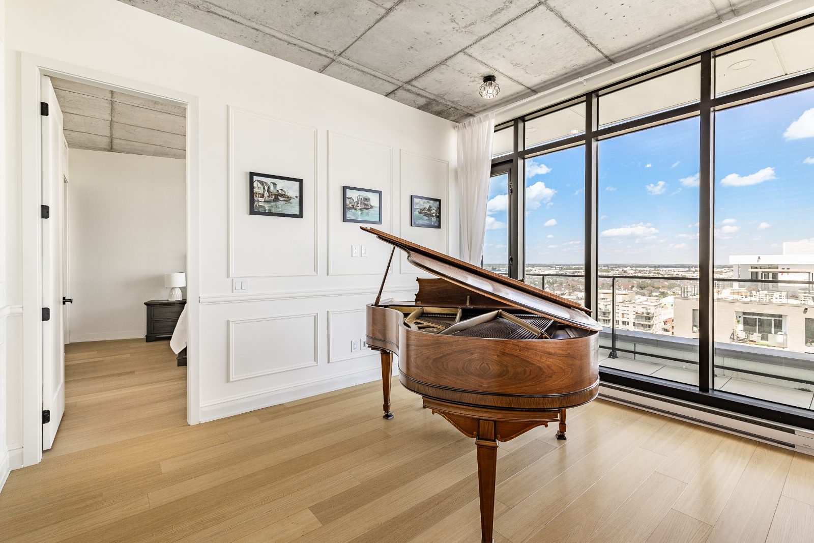 Music corner with grand piano in front of the floor-to-ceiling windows