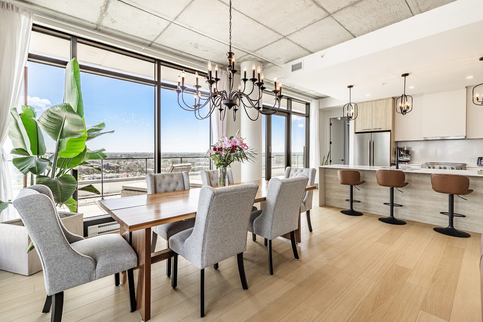 Dining room with chandelier and floor-to-ceiling windows over the city