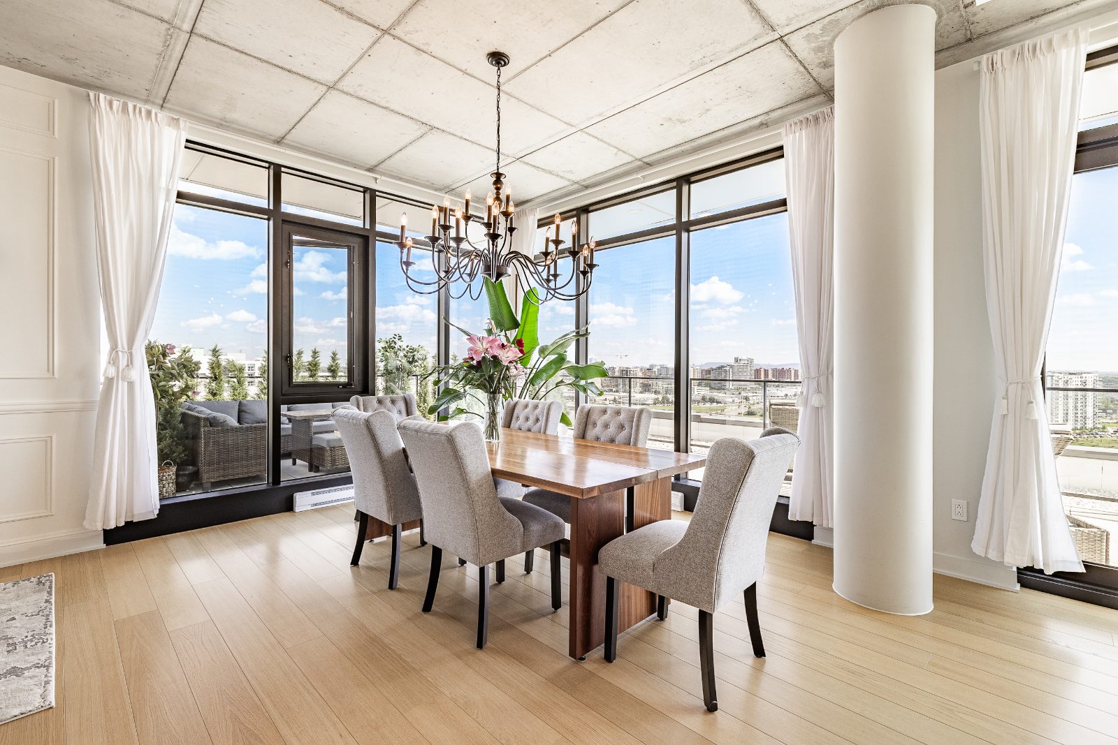Elegant dining room surrounded by windows with city views