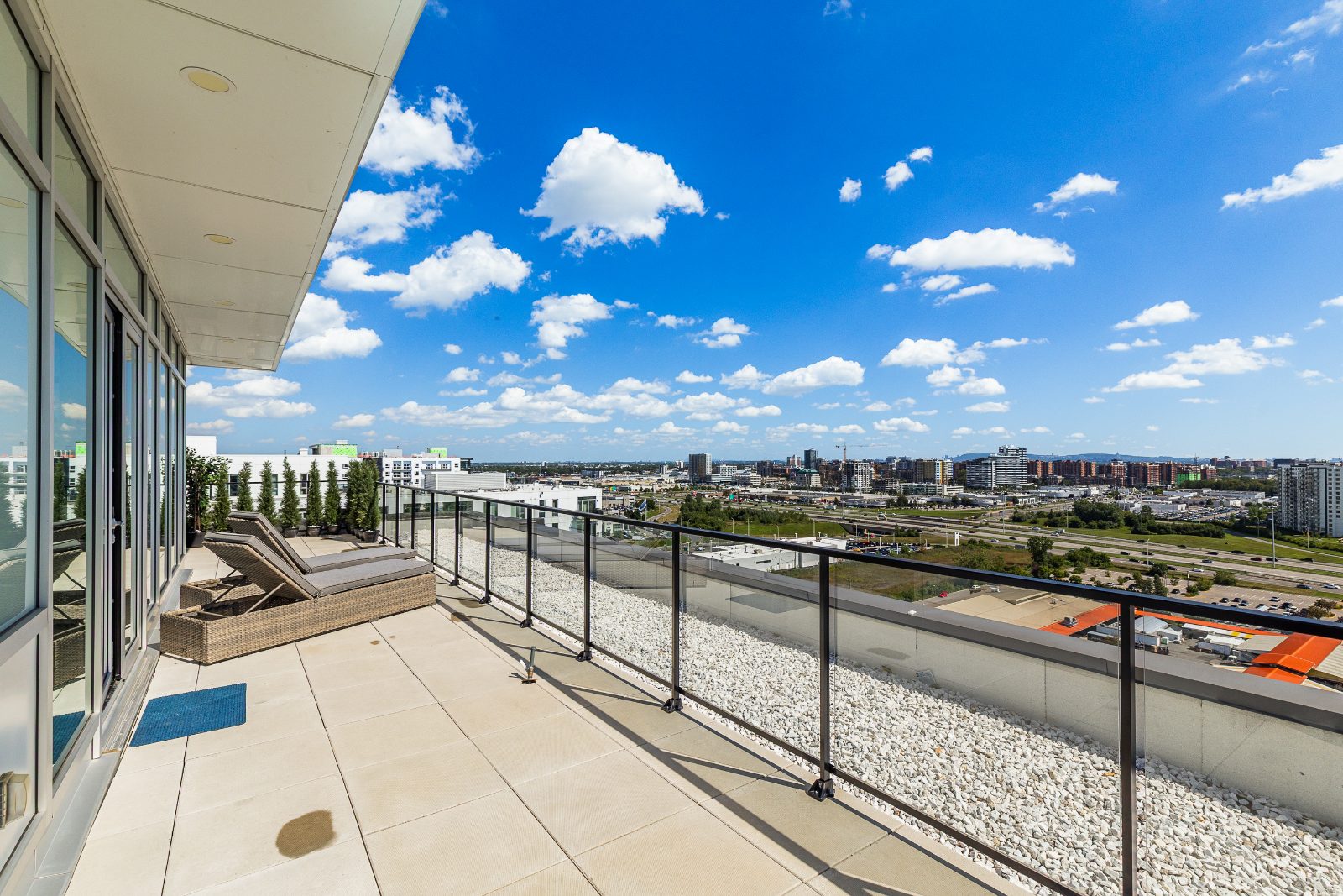 Private terrace with glass railing and open horizon views